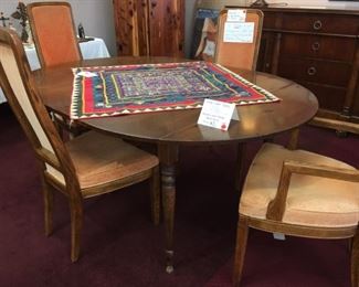 Drop-leaf vintage table with 2 leaves sold with 6 Black Windsor Chairs by Nichols and Stone.  4 Henredon mid-century chairs sold separately (2 arm chairs).