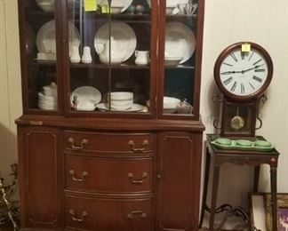 vintage china cabinet, small wooden table, wall clock