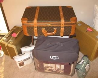 Authentic Louis Vuitton suitcase (center), Pair of  1950's suitcases (left), Mark Cross suitcase (right), UGG twin comforter set (center front)