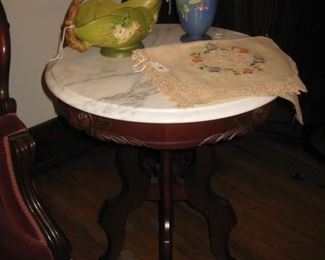 one of a pair of marble top tables