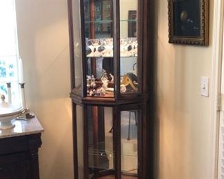 Mahogany finish corner curio cabinet with lighted interior