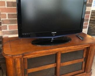 Samsung flatscreen TV and media cabinet/credenza with sliding glass doors