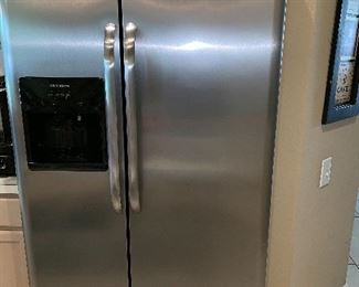 Frigidaire side by side stainless steel 
With water and ice in door