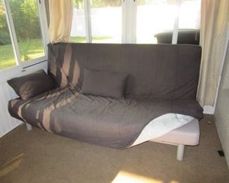 modern futon with cover and pillows
