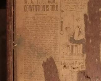 Newspaper article on top of cabinet, shows age.