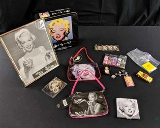 Marilyn Monroe Lot of Collectibles - 8x10 framed photo of "Diamonds are a girl's best friend".2. Collectible tin with Andy Warhol pop art painting;6 cigarette lighters; 1 cigarette case; 1 matchbook of "Marilyn Monroe Fan Club"3. bracelet; 2 clutch purses; keychain; necklace; and "Seven Year Itch" toy car.