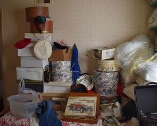 many hatboxes with ladies hats of al styles and at least one man's wide-brim hat, plus new in box Mercedes plastic model