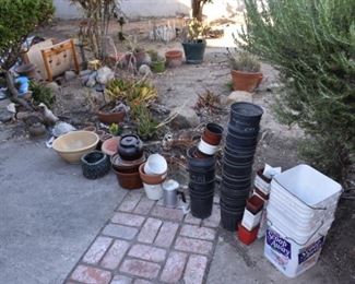 lots of planters and gardening supplies / tools