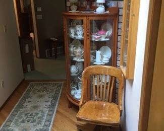 a view of one of four display cases-mostly lighted-old office chair