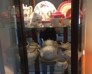 teapots in lighted cabinet
