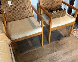 Two of four available; MCM cane arm dining chairs.