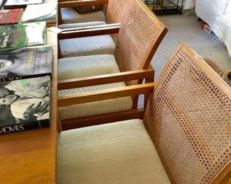 Set of four MCM cane arm dining chairs.