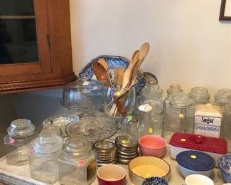 Ramekins, bowls, glass canisters, wooden utensils, cake stand with cover, tin drink coasters