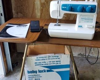 Baby lock denim pro II sewing machine with operators manual, box, and table