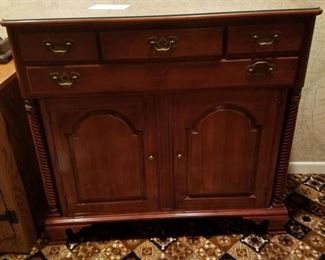 Four drawer/two door cherry cabinet, with matching table and chairs