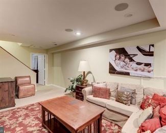 Coffee table pictured in the center of the room, dresser on left side of the room
