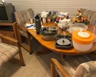 Oak dining table with 4 padded chairs on wheels