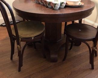 Antique round oak table with bentwood chairs