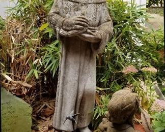 Many outdoor sculptures, pots, and other decor