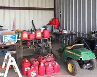 Assorted Gas Cans, John Deere Airplane Tow, Shelving, Orange Coast Guard Suit