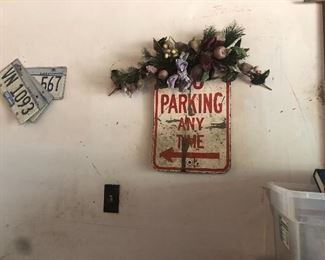 no parking sign, lots of old license plates