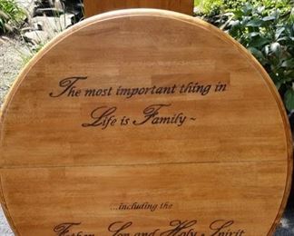 Beautiful Center Leg, Round Table with Center Leaf and "The Most Important Thing in Life is Family... Including the Father, Son and the Holy Spirit" written on it.