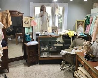 Christening garments - from 19th century on, vintage children’s clothing, doll clothing, many dolls (porcelain, rubber), Victorian golden oak vanity, mannequins, commercial display and folding mirror, excellent oak work table, Hummels, vintage stroller, and more just in one photo!