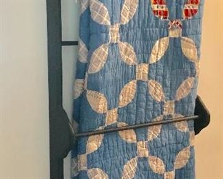 Wall hanging quilt rack and hand made blue quilt