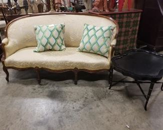 settee. coffee table, fine fabric pillows