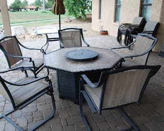 Patio table and chairs with built in fire pit