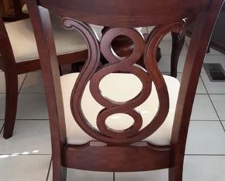 Lovely pedestal dining room table with one leaf and 6 unique chairs (2 not pictured).