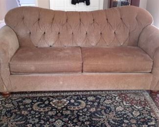 Beige rolled arm and tufted sofa and love seat from Dillards.