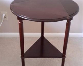 Unique drop leaf table...twist the top to raise the leaves. 