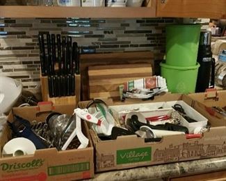 lots of utensils, cutting boards, complete knife set
