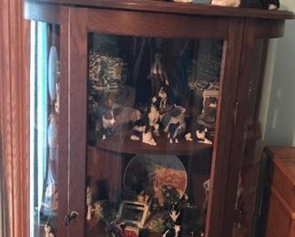 Bow front china cabinet with large collection of Border Collies.