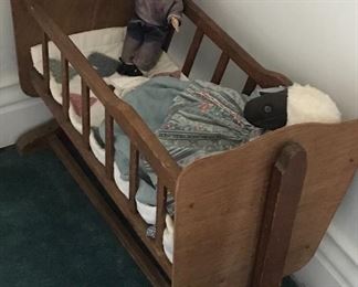 Older cradle with dolls