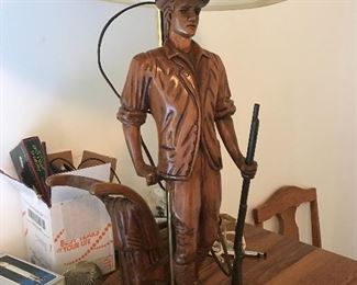 Hand carved wood lamp with metal gun .