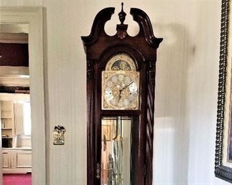 Howard Miller Benjamin Grandfather clock, model 610-983 in windsor cherry, polished brass finished dial; plays chimes at 1/4, 1/2 and 3/4 hour with full chime & strike on the hour. 