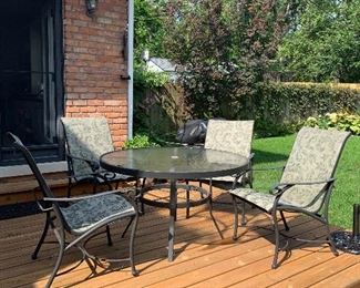 134- Patio set with glass top table and four chairs