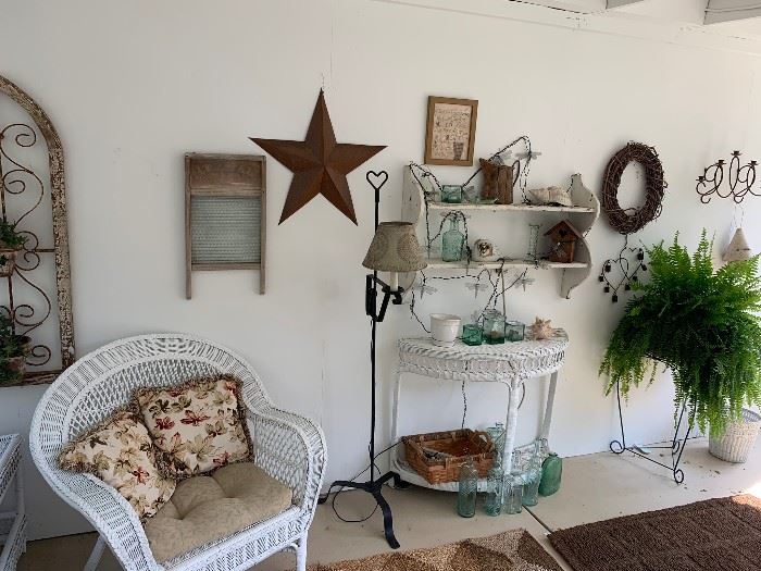 137- Country style iron and wood wall plant holder, vintage washboard, rusted metal wall star, iron floor lamp, wicker furniture, decorative glass bottle, wreath, live fern and plant stand