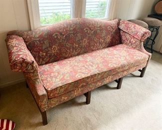 38- Red-tone floral camelback sofa measures 80" w x 30" deep x 32" tall