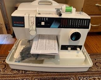 62. Singer Model 9030  portable sewing machine with cover and carrying handle