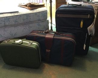 Three sets of luggage. One set is new.