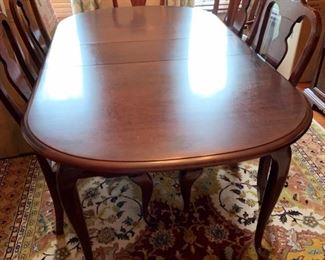 Cherry dining room table w/six chairs (two chairs have arms). Part of dining room suite for sale.