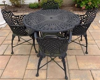 Cast aluminum patio table with four chairs.