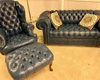 Leather Chesterfield Style sofa with matching armchair and ottoman. Features rich, smoky blue leather and nailhead trim