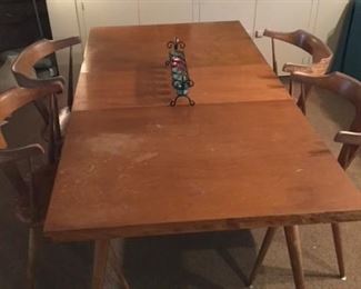 A PAUL MCCOBB DINING TABLE IN MAPLE AND SHOWN WITH ONE OF THE 2 LEAVES
