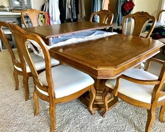 Beautifully elegant wooden dining room table and chairs with leaf and 9 chairs 