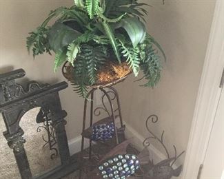Plant stand with artificial plants and fish wall art