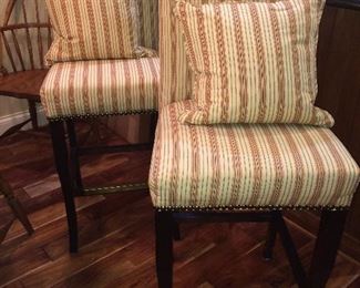 Custom upholstered bar stools and matching pillows.